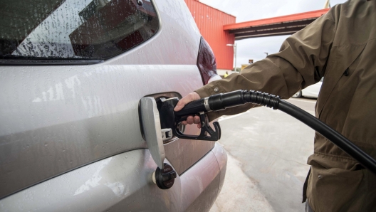 epaselect epa09863195 A man fills up his at a gas station in the town of Sant Luis, Menorca island, eastern Spain, 01 April 2022. The Spanish Government began on 01 April to subsidize the fuel price with a minimum reduction of 20 euro cents per liter of fuel to try to deal with the hike of prices amid the Russian invasion of Ukraine and after a strike called by hauliers. The measure will be in effect until next 30 June.  EPA/David Arquimbau Sintes