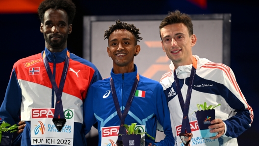 MUNICH, GERMANY - AUGUST 21: Silver medalist Zerei Kbrom Mezngi of Norway, Gold medalist Yemaneberhan Crippa of Italy, and Bronze medalist Yann Schrub of France celebrate on the podium during the medal ceremony Men's 10,000m Final on day 11 of the European Championships Munich 2022 at Olympiapark on August 21, 2022 in Munich, Germany. (Photo by Matthias Hangst/Getty Images)