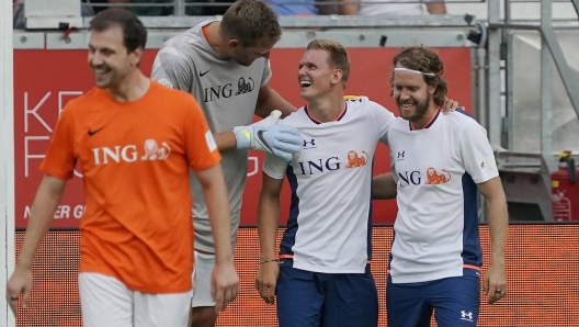 epa10136626 (L-R) German former NBA player Dirk Nowitzki, German Formula One driver Mick Schumacher and German Formula One driver Sebasstian Vettel react during the Champions for Charity charity soccer match in Frankfurt, Germany, 24 August 2022. The match is held in honor of former Formula 1 driver Michael Schumacher.  EPA/RONALD WITTEK