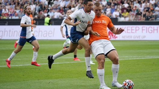 epa10136569 German circus artist Rene Casselly (L) in action against German bobsledder Thorsten Margis (R) during the Champions for Charity soccer match in Frankfurt, Germany, 24 August 2022. The match is held in honor of former Formula 1 driver Michael Schumacher.  EPA/RONALD WITTEK