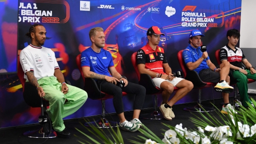 ( from l-R) Mercedes' British driver Lewis Hamilton, Haas F1 Team's Danish driver Kevin Magnussen, Ferrari's Monegasque driver Charles Leclerc, Alpine's Spanish driver Fernando Alonso and Alfa Romeo Chinese driver Zhou Guanyu attend a press conference ahead of the Formula One Belgian Grand Prix at the Spa-Francorchamps motor racing circuit in Liege on August 25, 2022. - The Formula One Belgian Grand Prix will take place on August 28, 2022. (Photo by John THYS / AFP)