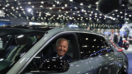 President Joe Biden drives a Cadillac Lyriq through the show room during a tour at the Detroit Auto Show, Wednesday, Sept. 14, 2022, in Detroit. (AP Photo/Evan Vucci)