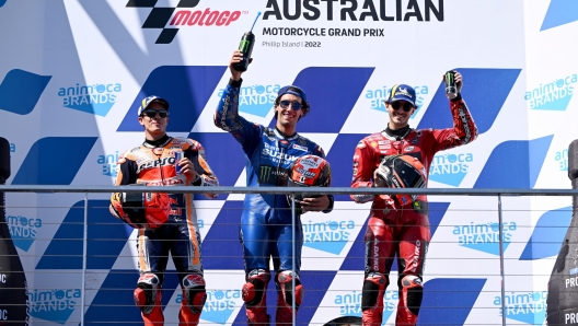 epa10246444 First place Alex Rins of Spain riding for Suzuki Ecstar (C) celebrates on the podium with second place Marc Marquez of Spain riding for Repsol Honda Team (L) and third place Francesco Bagnaia of Italy riding for Ducati Lenovo Team (R) after the MotoGP race  race at the Australian Motorcycle Grand Prix at the Phillip Island Grand Prix Circuit on Phillip Island, Victoria, Australia, 16 October 2022.  EPA/JOEL CARRETT AUSTRALIA AND NEW ZEALAND OUT