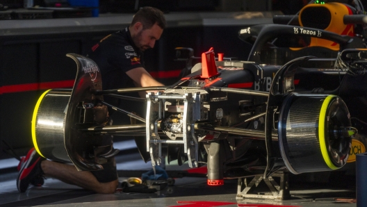 epa10255974 A Red Bull Racing team member works on Sergio Perez's car in the Red Bull garage at the Circuit of The Americas in Austin, Texas, USA, 20 October 2022. The Formula One Grand Prix of the USA takes place on 23 October 2022.  EPA/SHAWN THEW