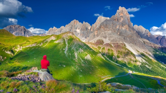 Climber admiring of the landscape of Pale di San Martino, Trentino - Dolomites, Italy. Cimon della Pala mountain ridge.