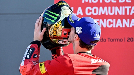 Ducati Italian rider Francesco Bagnaia celebrates as he won the World Championship's title after the Valencia MotoGP Grand Prix race at the Ricardo Tormo racetrack in Cheste, near Valencia, on November 6, 2022. (Photo by JAVIER SORIANO / AFP)