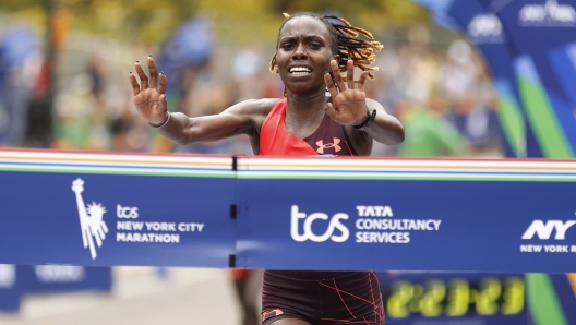 Sharon Lokedi, of Kenya, crosses the finish line first in the women's division of the New York City Marathon, Sunday, Nov. 6, 2022, in New York. (AP Photo/Jason DeCrow)