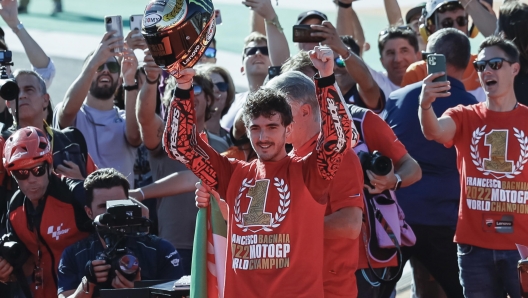 epa10290221 Moto GP rider Francesco Bagnaia (C) celebrates after becoming world champion of his category during the Comunidad Valenciana Motorcycling Grand Prix at Ricardo Tormo Circuit in Cheste, Valencia, 06 November 2022.  EPA/Biel Alino