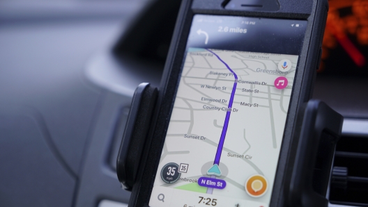 FILE - Former police data analyst Davin Hall uses the Waze navigation app while driving through Greensboro, N.C., on Wednesday, June 22, 2022. Hall quit the city's police force in part over its use of Fog Reveal, a powerful cellphone-tracking tool that the company says uses data from apps like Waze to track mobile devices. (AP Photo/Allen G. Breed, File)