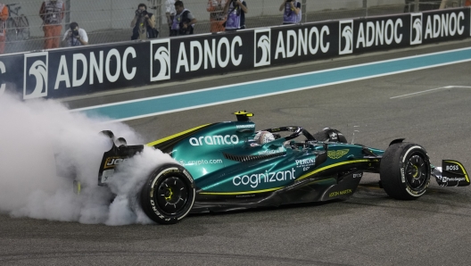 Aston Martin driver Sebastian Vettel of Germany burns the tires as he finished his last race in career at the Formula One Abu Dhabi Grand Prix, in Abu Dhabi, United Arab Emirates Sunday, Nov.20, 2022. (AP Photo/Kamran Jebreili, Pool)