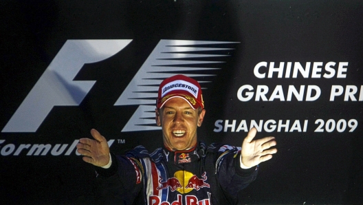 epa01701895 German Formula One driver Sebastian Vettel of Red Bull celebrates on the podium after winning the 2009 Formula 1 Grand Prix at the Shanghai International Circuit, Shangai, China, 19 April 2009. Vettel finished first followed by Australian teammate Formula One driver Mark Webber of Red Bull in second place and British Formula One driver Jenson Button of Brawn GP in third.  EPA/DIEGO AZUBEL