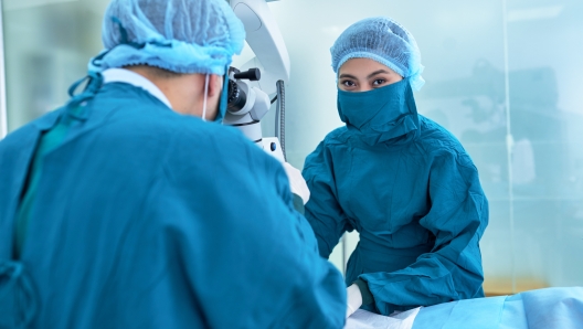 Nurse assisting doctor during surgery