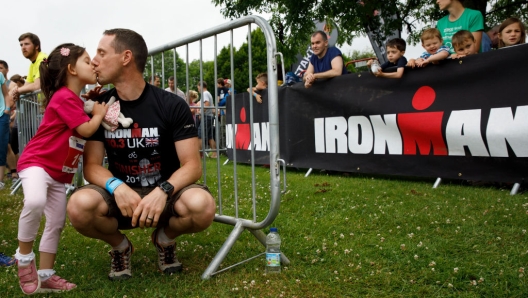 SOMERSET, UNITED KINGDOM - JUNE 24:  A father kisses his daughter prior to start the Iron Kids race the day before of Ironman 70.3 UK Exmoor at Wimbleball Lake on June 24, 2017 in Somerset, United Kingdom.  (Photo by Gonzalo Arroyo Moreno/Getty Images for Ironman)