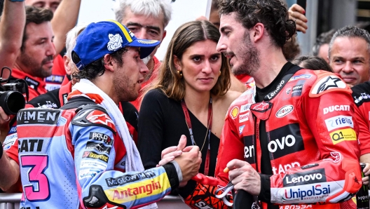 Second-placed Ducati Gresini Racing's Italian rider Enea Bastianini (L) congratulates winner Ducati Lenovo's Italian rider Francesco Bagnaia (R) after the MotoGP Malaysian Grand Prix motorcycle race at the Sepang International Circuit in Sepang on October 23, 2022. (Photo by MOHD RASFAN / AFP)