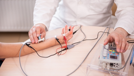 Patient nerves testing using electromyography at medical center.