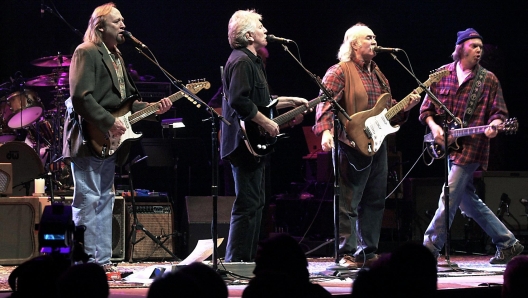 (FILES) In this file photo taken on January 24, 2000 Stephen Stills, (L) Graham Nash (2nd L), David Crosby (2nd R) and Neil Young (R) perform live for the first time since 1974 at the Palace of Auburn Hill, Michigan. - Folk-rock pioneer David Crosby dies on January 19, 2023, at 81, according to US media (Photo by JEFF KOWALSKY / AFP)