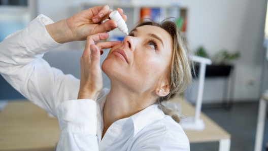 Business woman office worker dripping eye drops