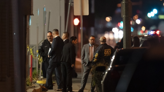 Investigators gather at a scene where a shooting took place in Monterey Park, Calif., Sunday, Jan. 22, 2023. Dozens of police officers responded to reports of a shooting that occurred after a large Lunar New Year celebration in a community east of Los Angeles late Saturday. (AP Photo/Jae C. Hong)