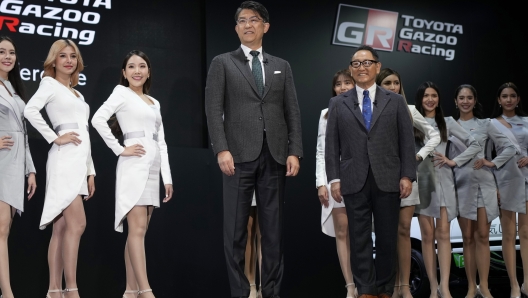 FILE - Toyota Motor Corp. Chief Executive Akio Toyoda, right, and Koji Sato, Toyota Gazoo Racing Company president, left, pose on the stage at the Tokyo Auto Salon, an industry event similar to the world's auto shows Friday, Jan. 13, 2023, in Chiba near Tokyo. Toyota Motor Corp. has announced Thursday, Jan. 26, 2023, that Toyoda, will become chairman and Sato will succeed him. (AP Photo/Eugene Hoshiko, File)