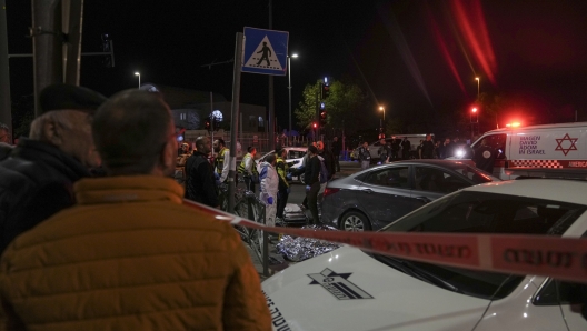 Victims of a shooting attack are covered on the ground near a synagogue in Jerusalem , Friday, Jan. 27, 2023. Israel's national rescue service Mada says a gunman killed five people and wounded three others in a shooting near a synagogue Friday night in east Jerusalem in one of the deadliest attacks on Israelis in years. The gunman was shot and reportedly killed. (AP Photo/Mahmoud Illean)