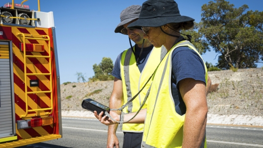 In this photo provided by the Department of Fire and Emergency Services, its members search for a radioactive capsule believed to have fallen off a truck being transported on a freight route on the outskirts of Perth, Australia, Saturday, Jan. 28, 2023. A mining corporation on Sunday apologized for losing the highly radioactive capsule over a 1,400-kilometer (870-mile) stretch of Western Australia, as authorities combed parts of the road looking for the tiny but dangerous substance. (Department of Fire and Emergency Services via AP)