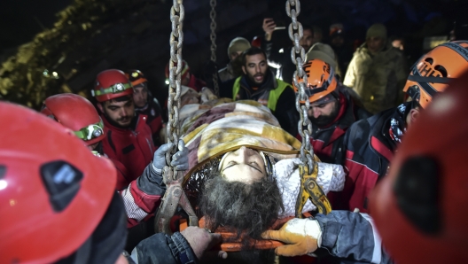 Rescue teams use a crane to rescue Nur Bayraktar in Kahramanmaras, southern Turkey, late Friday, Feb. 10, 2023. Friday, Feb. 10, 2023. Emergency crews made a series of dramatic rescues in Turkey on Friday, pulling several people, some almost unscathed, from the rubble, four days after a catastrophic earthquake killed more than 20,000.(Ismail Coskun/IHA via AP)