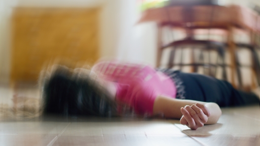 Woman lying on the floor at home, epilepsy, unconsciousness, faint, stroke, accident  or other health problem, healthcare and medical concept