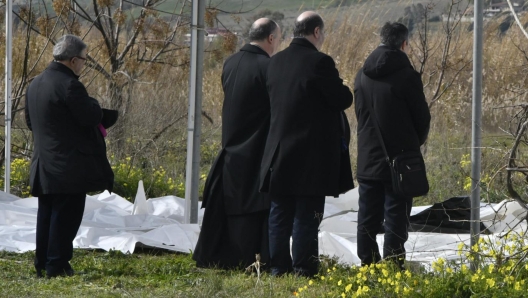 The Archbishop of Crotone Angelo Raffaele Panzetta blesses the bodies of dead migrants recovered after they washed ashore following a shipwreck, at a beach near Cutro, Crotone province, southern Italy, 26 February 2023. Italian authorities recovered at least 40 bodies on the beach and in the sea near Crotone, in the southern Italian region of Calabria, after a boat carrying migrants sank in rough seas near the coast. About forty people survived the accident, Authorities fear the death toll will climb as rescuers look for survivors. ANSA/ GIUSEPPE PIPITA