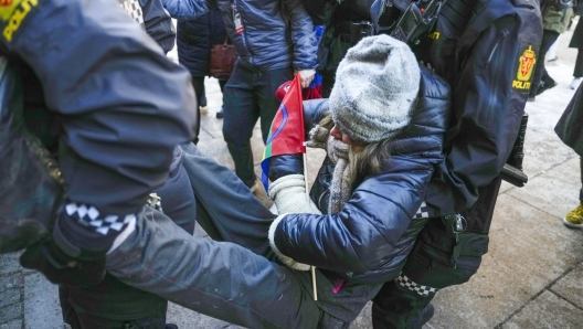 epa10496456 Police remove Swedish environmental activist Greta Thunberg (C) and other campaigners as they demonstrate outside the norway's Ministry of Finance entrance and several other ministries in a protest against still operating wind turbines at Fosen, in Oslo, Norway, 01 March 2023. Norway's Supreme Court has ruled in 2021 the wind turbines at Fosen are illegal.  EPA/JAVAD PARSA  NORWAY OUT