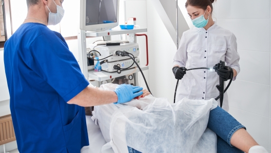 Doctor and nurse during endoscopy exam in clinic. Concentrated man calming his patient before the gastroscopy at the modern clinic