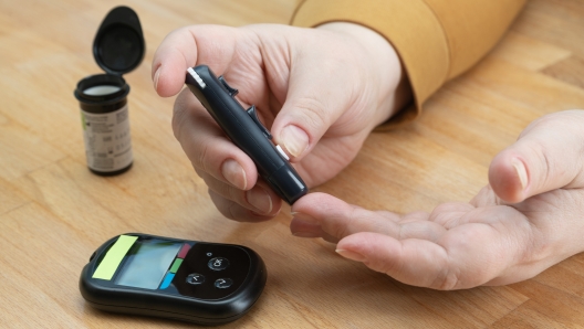 Senior woman makes blood glucose test