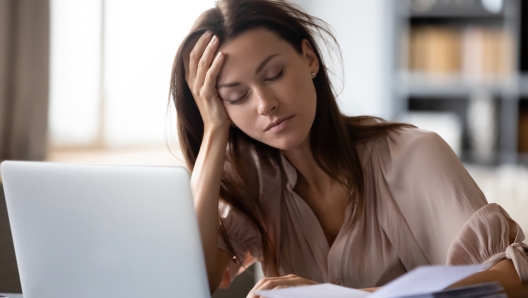 Tired millennial girl student sit at desk fall asleep studying late hours at laptop at home, exhausted young woman take nap sleep at workplace working on computer, exhaustion, fatigue concept