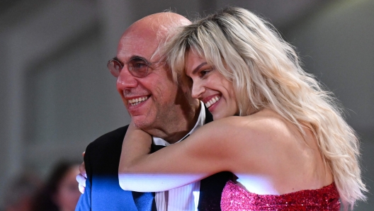 Italian director Paolo Virzi and his wife Italian actress Micaela Ramazzotti arrive on September 8, 2022 for the screening of the film "Siccita" presented out of competition as part of the 79th Venice International Film Festival at Lido di Venezia in Venice, Italy. (Photo by Tiziana FABI / AFP)