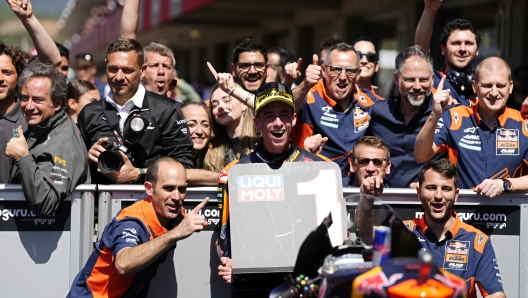 Moto2 rider Pedro Acosta of Spain poses with his team after winning the Portugal Motorcycle Grand Prix, at the Algarve International circuit near Portimao, Portugal, Sunday, March 26, 2023. (AP Photo/Jose Breton)