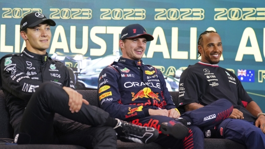 The top 3 fastest qualifiers, Mercedes driver George Russell of Britain, left, Red Bull driver Max Verstappen of Netherlands and Mercedes driver Lewis Hamilton of Britain, right, attend a press conference ahead of the Australian Formula One Grand Prix at Albert Park in Melbourne, Saturday, April 1, 2023. Verstappen qualified fasted, Russell second and Hamilton is 3rd. (AP Photo/Asanka Brendon Ratnayake)