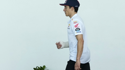 MotoGP rider Marc Marquez of Spain walks in the paddock after getting injured in a crash during the Portugal Motorcycle Grand Prix, at the Algarve International circuit near Portimao, Portugal, Sunday, March 26, 2023. (AP Photo/Jose Breton)