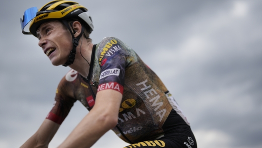 FILE - Stage winner and new overall leader Denmark's Jonas Vingegaard climbs Granon pass during the eleventh stage of the Tour de France cycling race over 152 kilometers (94.4 miles) with start in Albertville and finish in Col du Granon Serre Chevalier, France, Wednesday, July 13, 2022.  Tour de France champion Jonas Vingegaard will remain with Jumbo-Visma until the end of 2027, the Dutch team said on Tuesday, April 18, 2023. Vingegaard, who defeated Tadej Pogacar to win cycling's biggest race last year, joined Jumbo-Visma in 2019. He extended his contract by three years. (AP Photo/Thibault Camus, File)