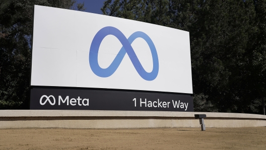 FILE - Facebook's Meta logo sign is seen at the company headquarters in Menlo Park, Calif., on Oct. 28, 2021. Facebook?s corporate parent has agreed to pay $725 million to settle a lawsuit alleging the world?s largest social media platform allowed millions of its users? personal information to be fed to Cambridge Analytica, a firm that supported Donald Trump?s victorious presidential campaign in 2016. (AP Photo/Tony Avelar, File)