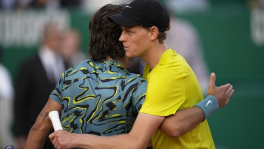 Jannik Sinner, of Italy, right, and Lorenzo Musetti, also of Italy, embrace at the end of their Monte Carlo Tennis Masters quarterfinals match in Monaco, Friday, April 14, 2023. Sinner won 6/2, 6/2. (AP Photo/Daniel Cole)