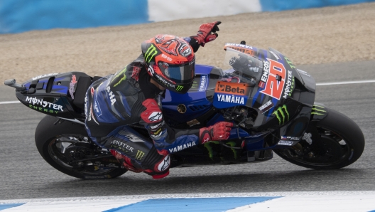 JEREZ DE LA FRONTERA, SPAIN - APRIL 30: Fabio Quartararo of France and Monster Energy Yamaha MotoGP Team greets the fans  and rounds the bend during the MotoGP wurm up  during the MotoGP Of Spain - Race on April 30, 2023 in Jerez de la Frontera, Spain. (Photo by Mirco Lazzari gp/Getty Images)