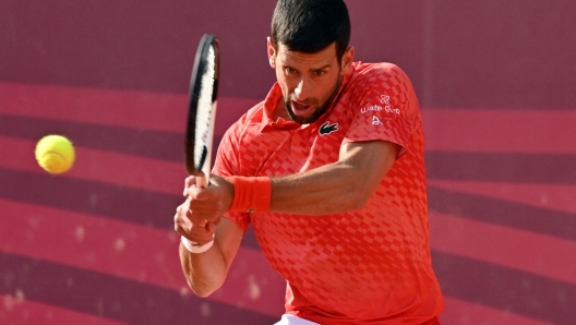 Serbia's Novak Djokovic plays a backhand return to Serbia's Dusan Lajovic, during their tennis quarter final singles match at Sprska Tennis Open ATP 250 series tournament in Banja Luka on April 21, 2023. (Photo by ELVIS BARUKCIC / AFP)