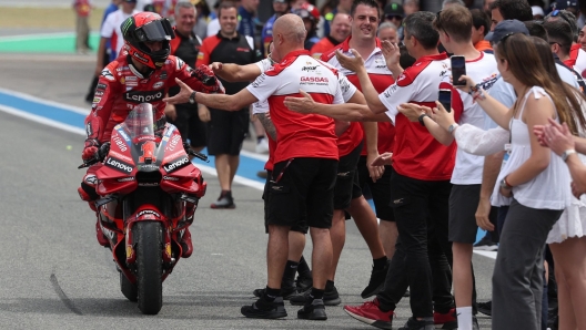 TOPSHOT - First placed Ducati Italian rider Francesco Bagnaia celebrates with team members after the MotoGP Spanish Grand Prix at the Jerez racetrack in Jerez de la Frontera on April 30, 2023. (Photo by Pierre-Philippe MARCOU / AFP)