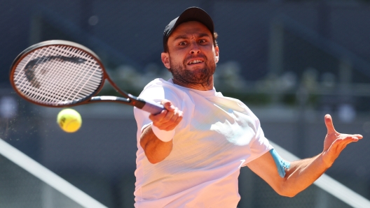 MADRID, SPAIN - MAY 04: Aslan Karatsev plays a forehand against Zhizhen Zhang of People's Republic of China during the Men's Quarter Final match on Day Eleven of the Mutua Madrid Open at La Caja Magica on May 04, 2023 in Madrid, Spain. (Photo by Julian Finney/Getty Images)