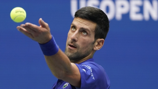 FILE - Novak Djokovic, of Serbia, serves to Daniil Medvedev, of Russia, during the men's singles final of the US Open tennis championships, Sunday, Sept. 12, 2021, in New York. Djokovic can return to the U.S. Open this year after missing the tournament in 2022, because the federal government's COVID-19 vaccination mandate for foreign air travelers will be gone as of next week. (AP Photo/John Minchillo, File)