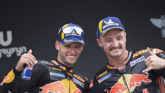 JEREZ DE LA FRONTERA, SPAIN - APRIL 30: (L-R) Brad Binder of South Africa and Red Bull KTM Factory Racing  and Jack Miller of Australia and Bull KTM Factory Racing  celebrate on the podium during the MotoGP race during the MotoGP Of Spain - Race on April 30, 2023 in Jerez de la Frontera, Spain. (Photo by Mirco Lazzari gp/Getty Images)