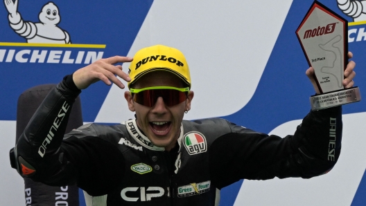 KTM Italian rider Andrea Migno celebrates his third place on the podium of the Argentina Grand Prix Moto2 race, at Termas de Rio Hondo circuit, in Santiago del Estero, Argentina, on April 2, 2023. (Photo by JUAN MABROMATA / AFP)