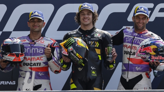 Moto GP race winner Italian rider Marco Bezzecchi of the Mooney VR46 Racing Team, center, poses with second placed Spain's rider Jorge Martin of the Prima Pramac Racing, left, and third placed France's rider Johann Zarco of the Prima Pramac Racing after the MotoGP race of the French Motorcycle Grand Prix at the Le Mans racetrack, in Le Mans, France, Sunday, May 14, 2023. (AP Photo/Jeremias Gonzalez)