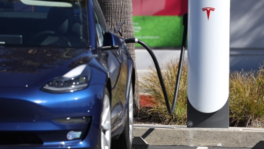 SAUSALITO, CALIFORNIA - FEBRUARY 15: A Tesla car sits at a Tesla Supercharger station on February 15, 2023 in Sausalito, California. Electric car company Tesla is partnering with the U.S. federal government to expand electric vehicle charging infrastructure in the United States. Tesla announced plans to open an estimated 7,500 of its Tesla Superchargers in the country to all brands of electric vehicles by the end of 2024.   Justin Sullivan/Getty Images/AFP (Photo by JUSTIN SULLIVAN / GETTY IMAGES NORTH AMERICA / Getty Images via AFP)