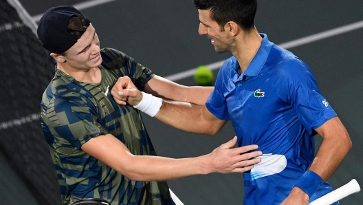 Denmark's Holger Rune (L) is congratulated by Serbia's Novak Djokovic after winning his men's singles final tennis match against Serbia's Novak Djokovic, on day 7 of the ATP World Tour Masters 1000 - Paris Masters (Paris Bercy) - indoor tennis tournament at The AccorHotels Arena in Paris on November 6, 2022. (Photo by JULIEN DE ROSA / AFP)