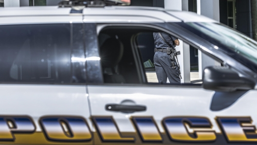 epa10604445 A police car and officer are seen as forces conduct a methodical search after responding to an active shooter call at the Florida International University (FIU) campus in Miami, Florida, USA, 02 May 2023. A false active shooter report led to a police response and several buildings on FIU main campus were evacuated. FIU security officials said they received reports of an active shooter at the Academic Health Center 3 building at the College of Nursing and Health Sciences.  EPA/CRISTOBAL HERRERA-ULASHKEVICH